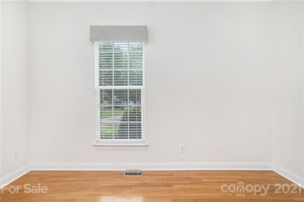 1416 Shade Tree Court Matthews, NC 28104 - Photo 16 of 22 a view of an empty room with wooden floor and a window