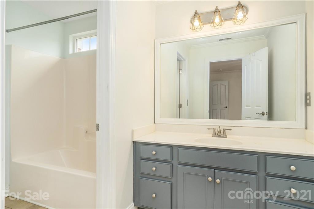 1416 Shade Tree Court Matthews, NC 28104 - Photo 18 of 22 a bathroom with a sink and a mirror