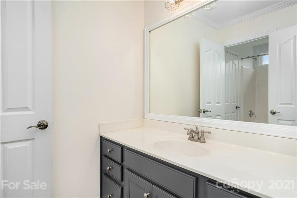 1416 Shade Tree Court Matthews, NC 28104 - Photo 19 of 22 a bathroom with a sink and a mirror