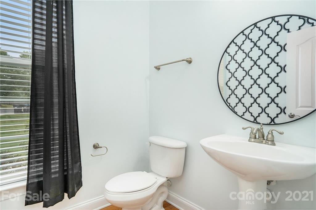 1416 Shade Tree Court Matthews, NC 28104 - Photo 20 of 22 a bathroom with a sink and a toilet