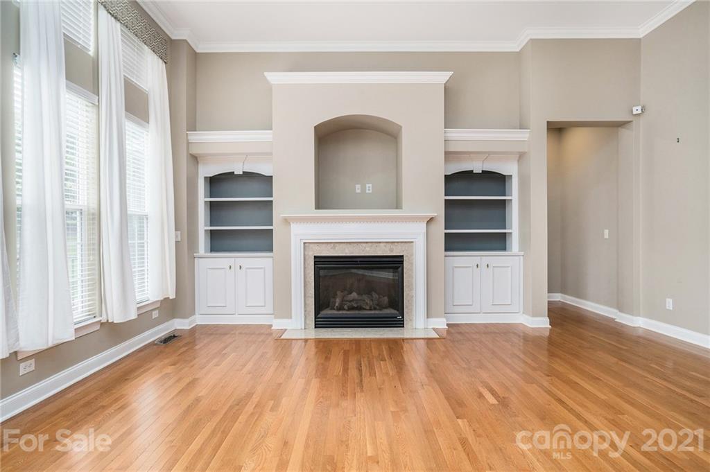 1416 Shade Tree Court Matthews, NC 28104 - Photo 6 of 22 a view of a livingroom with a fireplace wooden floor and windows