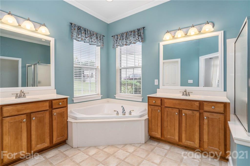 1416 Shade Tree Court Matthews, NC 28104 - Photo 7 of 22 a spacious bathroom with a tub sink and mirror