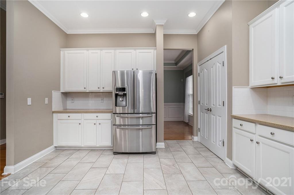1416 Shade Tree Court Matthews, NC 28104 - Photo 8 of 22 a kitchen with stainless steel appliances granite countertop a refrigerator and a stove top oven