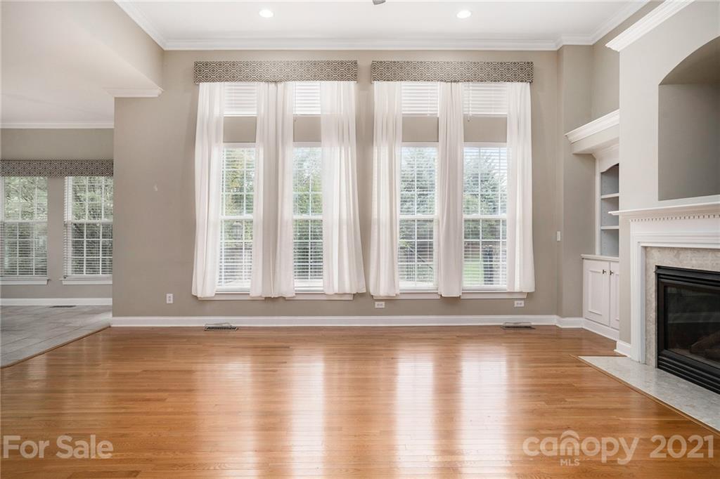 1416 Shade Tree Court Matthews, NC 28104 - Photo 10 of 22 a view of an empty room with wooden floor and a window