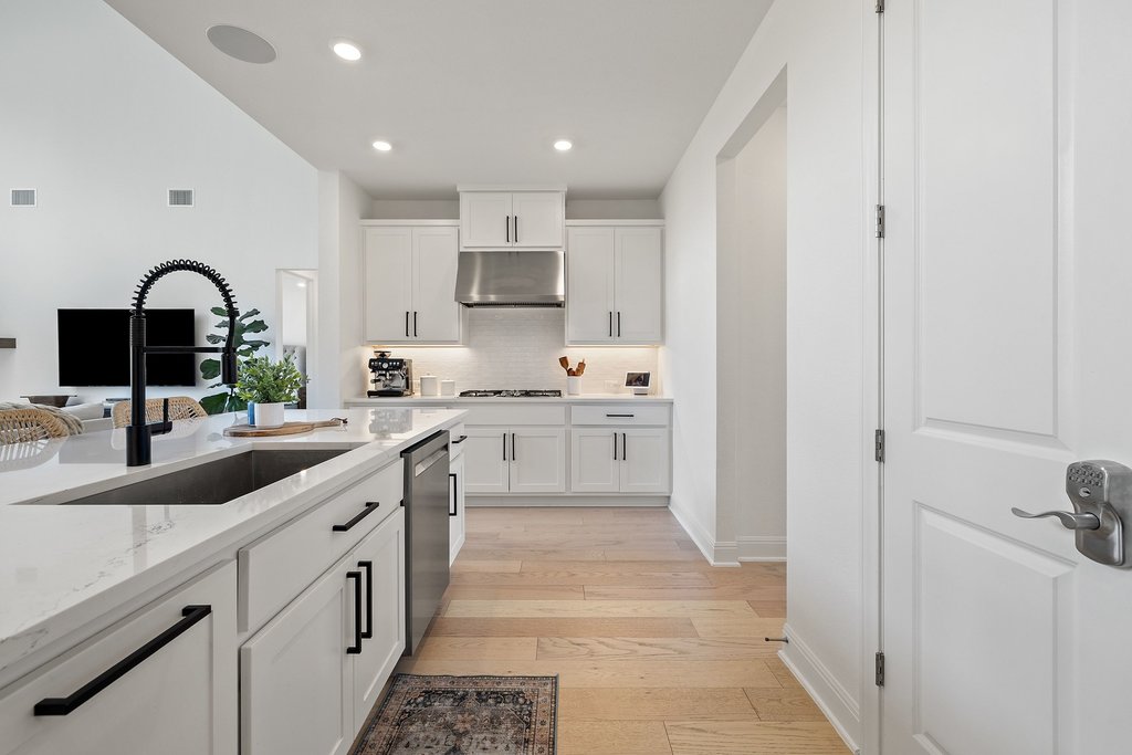 365 Pear Tree Lane Austin, TX 78737 - Photo 16 of 39 a kitchen with kitchen island white cabinets and sink