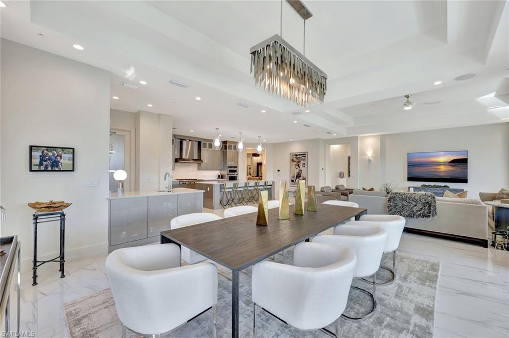 16350 Corsica Way, Unit 202 Naples, FL 34110 - Photo 11 of 39 a living room with furniture and a flat screen tv