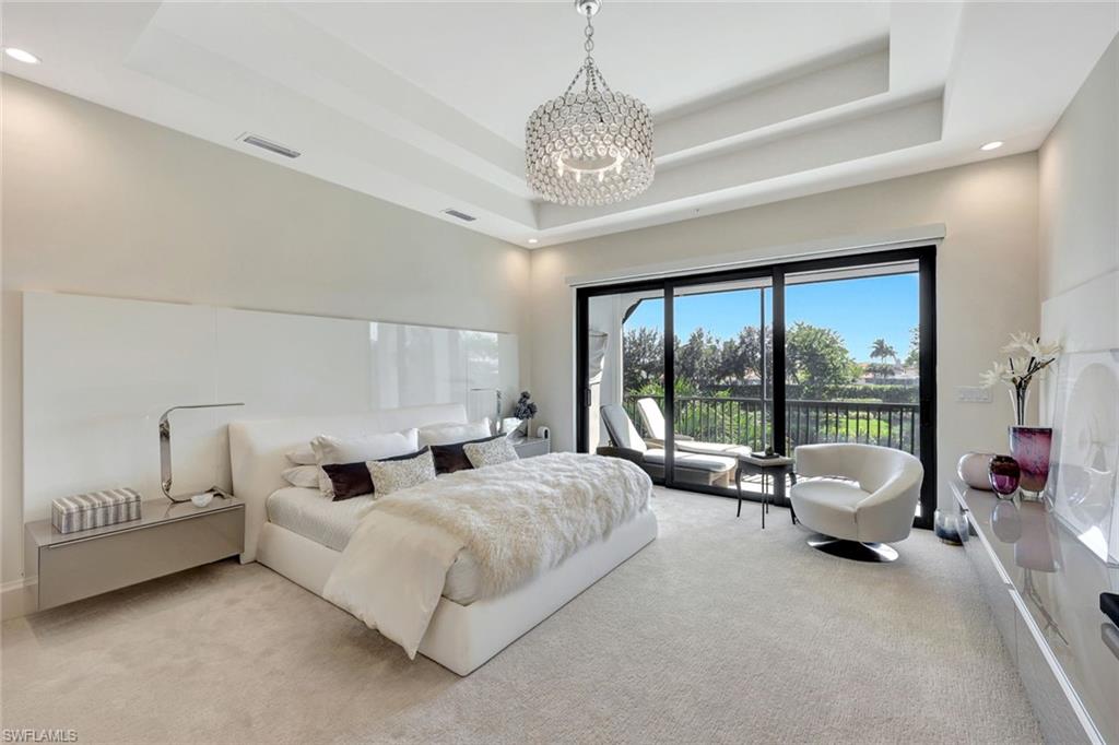 16350 Corsica Way, Unit 202 Naples, FL 34110 - Photo 13 of 39 a spacious bedroom with a bed and a large window