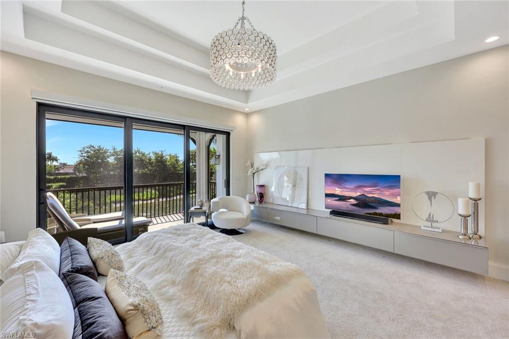 16350 Corsica Way, Unit 202 Naples, FL 34110 - Photo 14 of 39 a very nice looking room with a large window and a chandelier