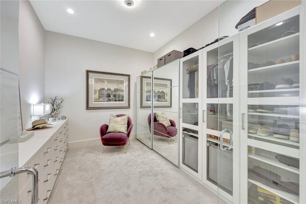 16350 Corsica Way, Unit 202 Naples, FL 34110 - Photo 15 of 39 a bedroom with furniture and wooden floor