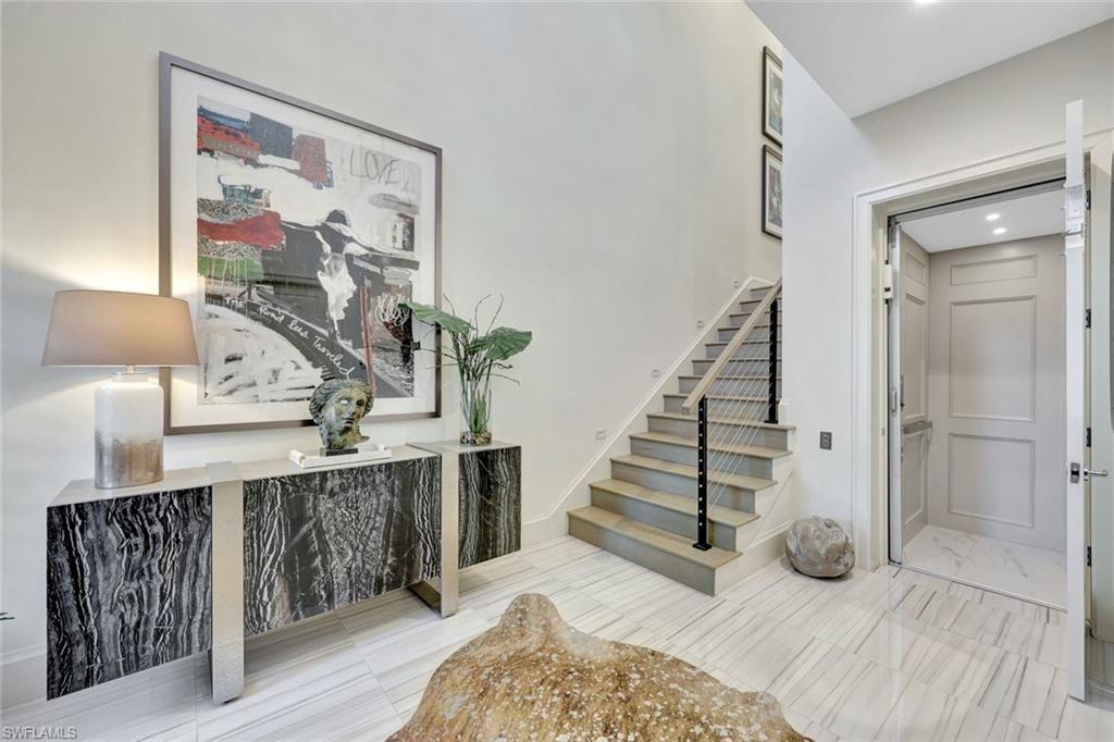 16350 Corsica Way, Unit 202 Naples, FL 34110 - Photo 19 of 39 a view of entryway and hall with wooden floor