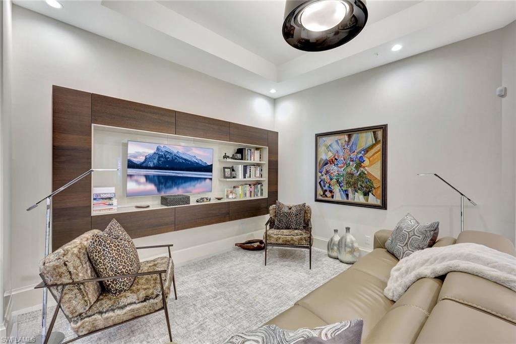 16350 Corsica Way, Unit 202 Naples, FL 34110 - Photo 21 of 39 a living room with furniture and a large mirror