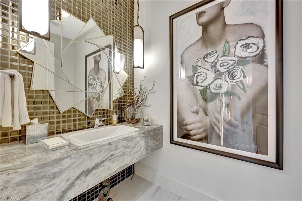 16350 Corsica Way, Unit 202 Naples, FL 34110 - Photo 22 of 39 a bedroom with a bed and painting on the wall