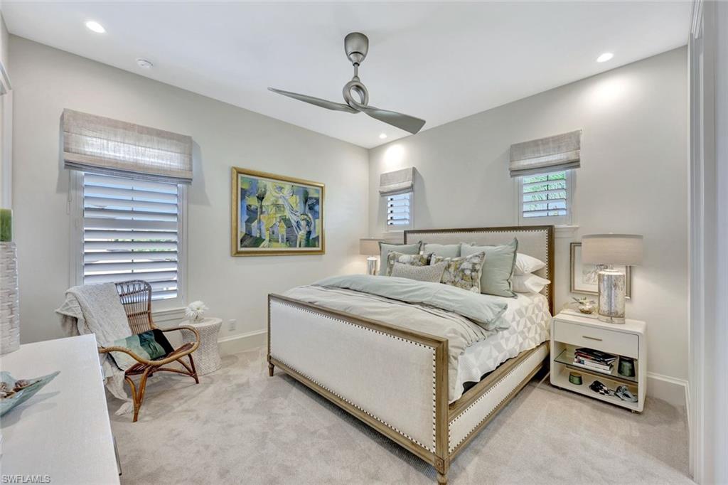 16350 Corsica Way, Unit 202 Naples, FL 34110 - Photo 23 of 39 a bedroom with a bed a table and chair