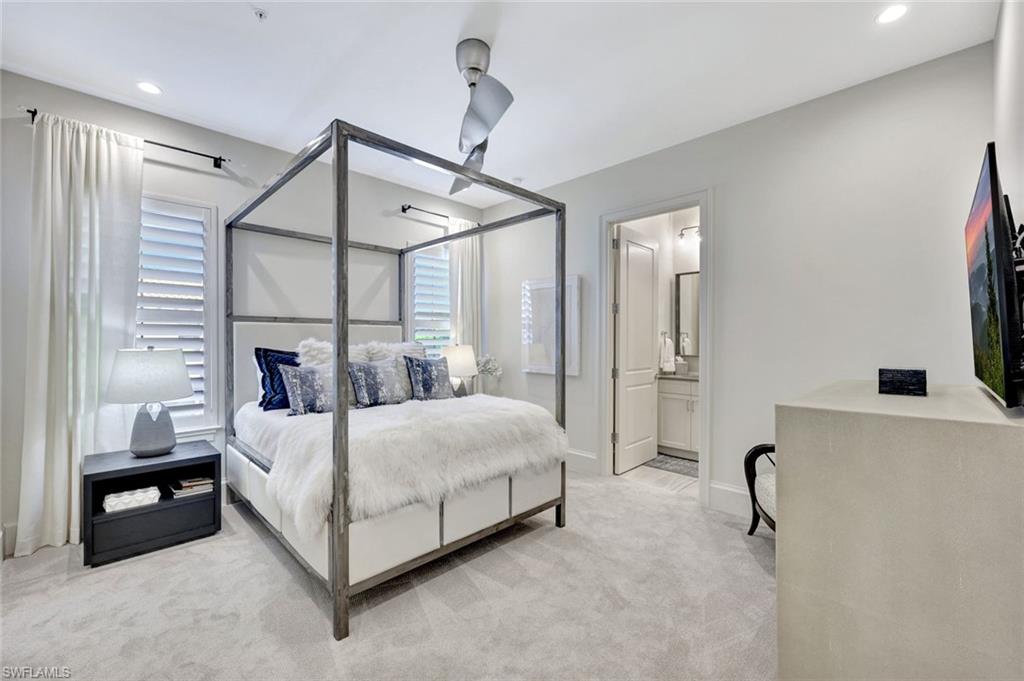 16350 Corsica Way, Unit 202 Naples, FL 34110 - Photo 25 of 39 a bedroom with a bed a mirror and a dresser