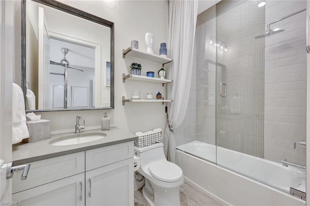 16350 Corsica Way, Unit 202 Naples, FL 34110 - Photo 26 of 39 a bathroom with a sink a toilet and shower