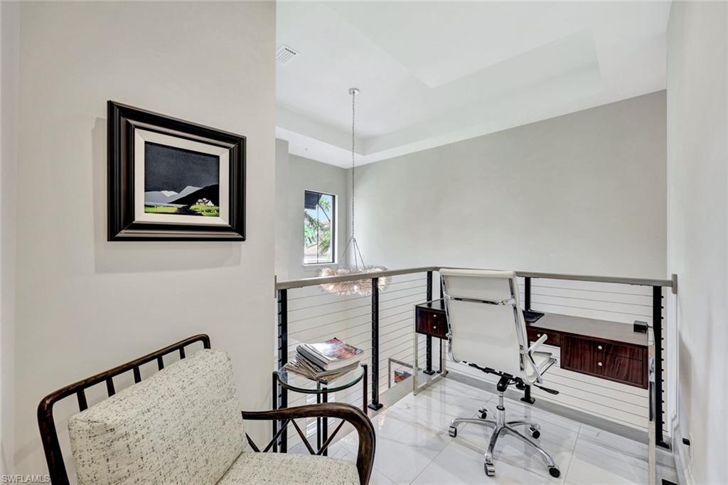 16350 Corsica Way, Unit 202 Naples, FL 34110 - Photo 27 of 39 a view of a workspace with furniture and white walls