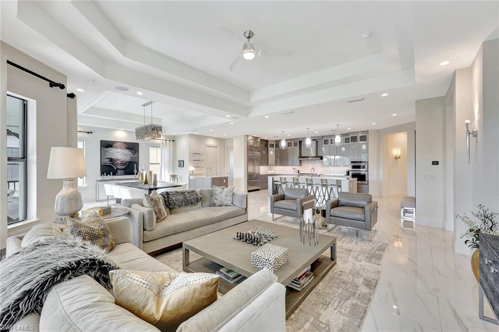 16350 Corsica Way, Unit 202 Naples, FL 34110 - Photo 5 of 39 a living room with furniture and a large window