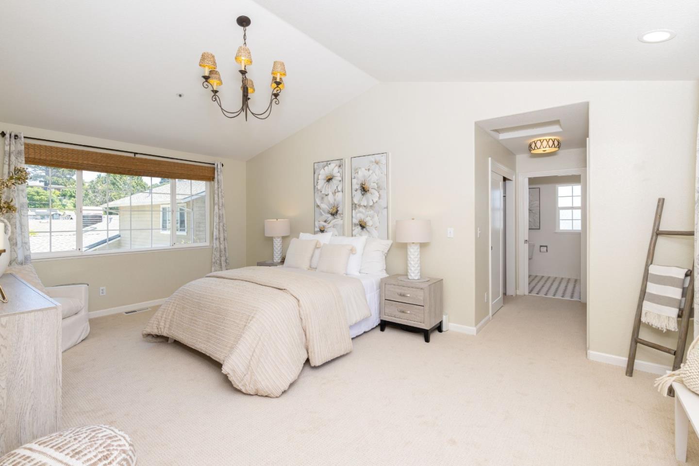 123 Reed Way Santa Cruz, CA 95060 - Photo 14 of 39 a bedroom with a large bed and a chandelier