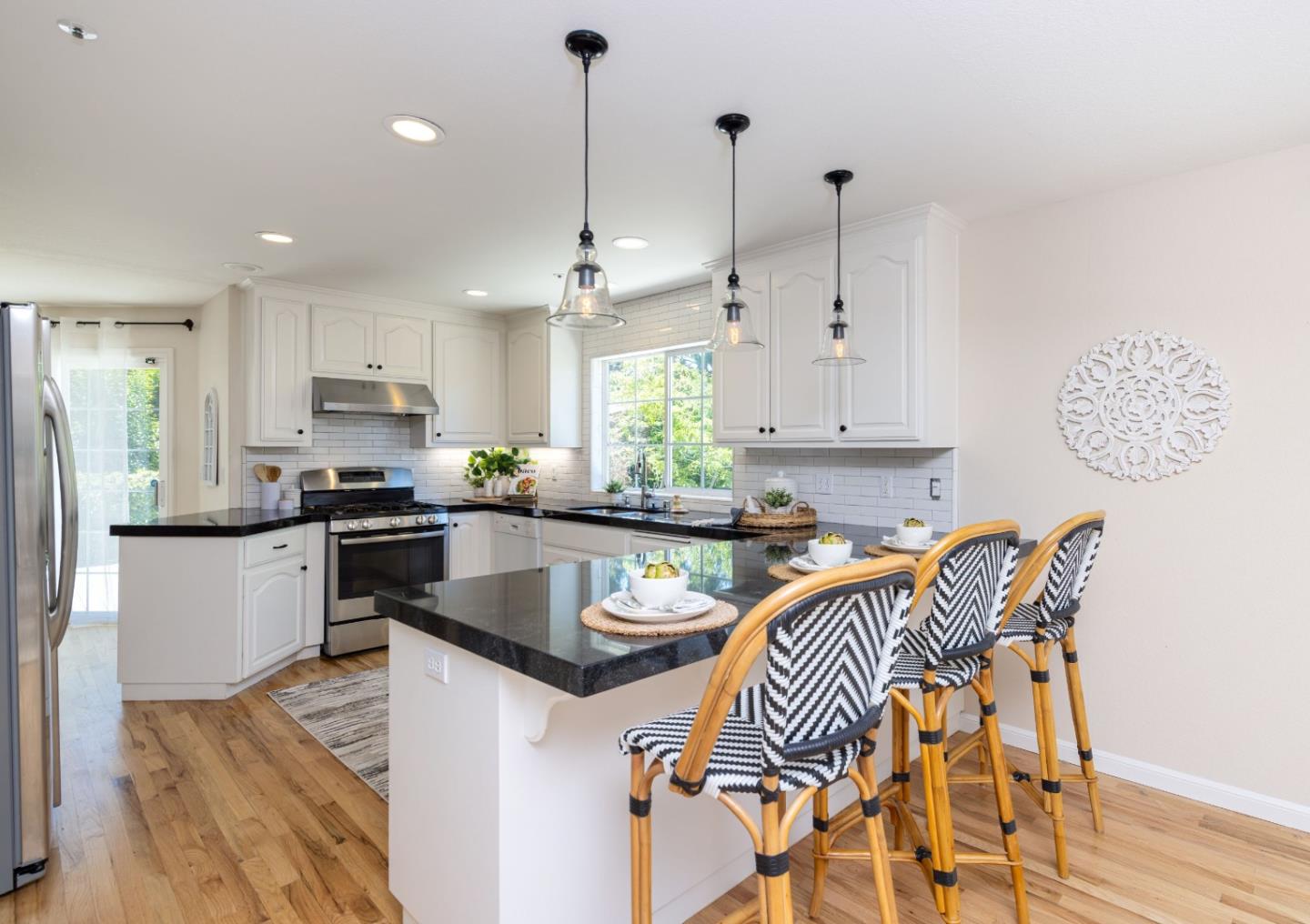 123 Reed Way Santa Cruz, CA 95060 - Photo 8 of 39 a kitchen with stainless steel appliances granite countertop a refrigerator a sink dishwasher a stove and white cabinets with wooden floor