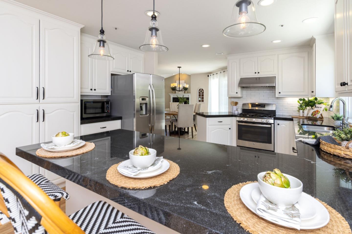 123 Reed Way Santa Cruz, CA 95060 - Photo 10 of 39 swimming kitchen with stainless steel appliances kitchen island granite countertop a stove and white cabinets