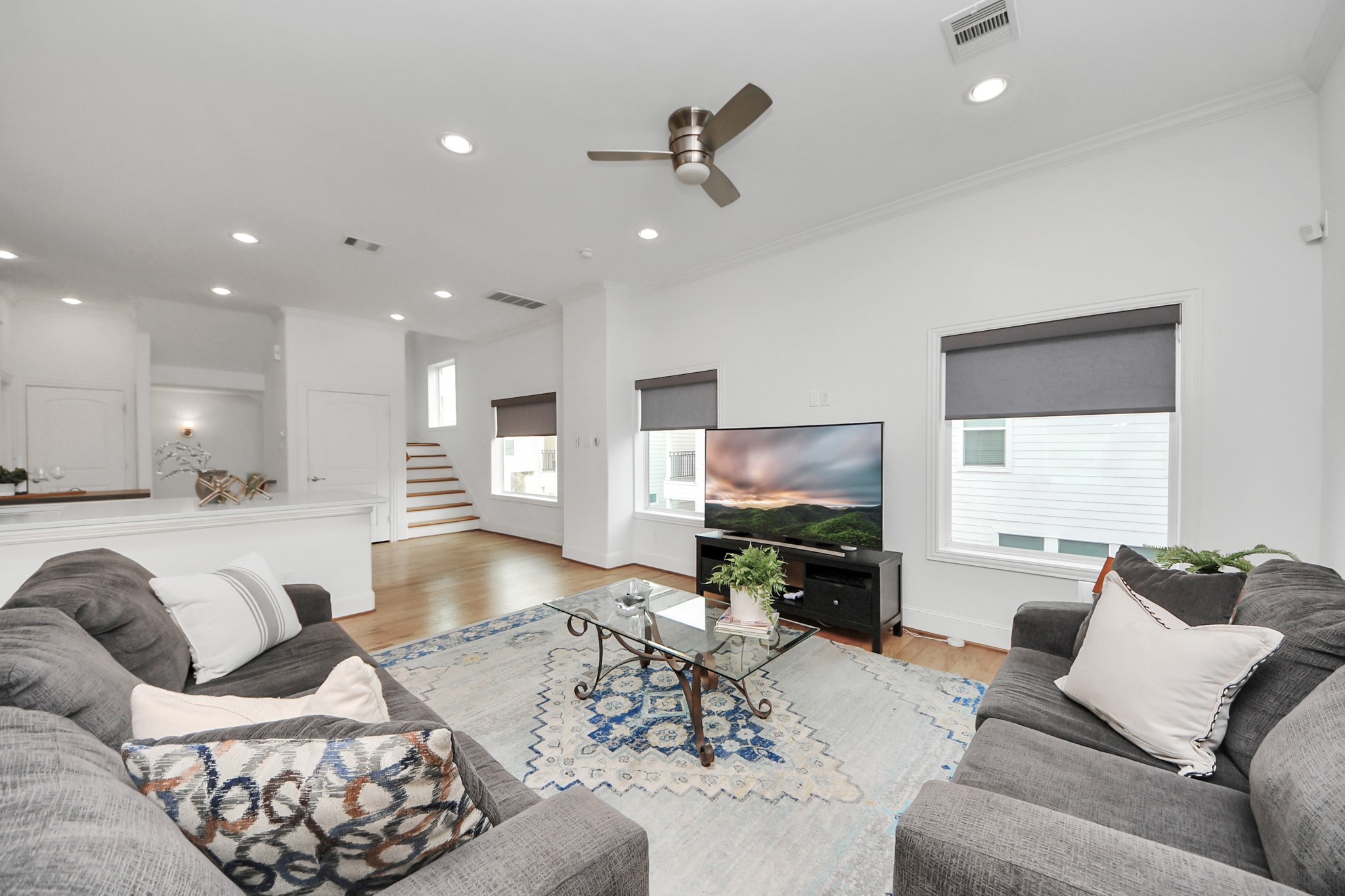 1628 West 24th Street Houston, TX 77008 - Photo 17 of 40 Bathe in natural light streaming through expansive picture windows, and effortlessly transition to a cozy movie night with the touch of a button to lower the electronic blinds.