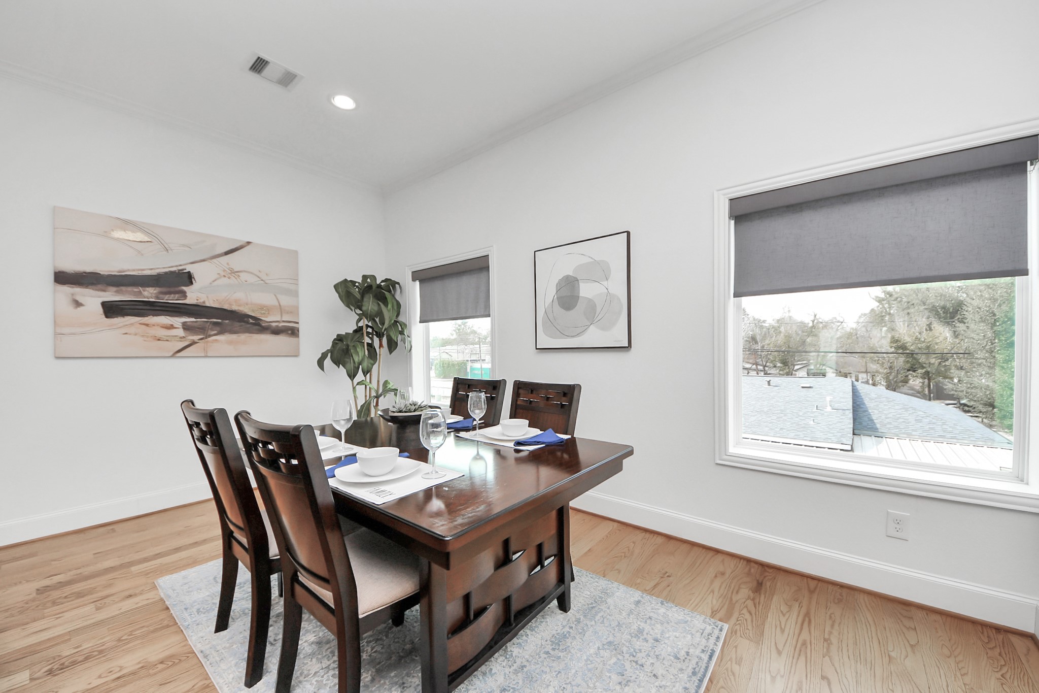 1628 West 24th Street Houston, TX 77008 - Photo 19 of 40 Bask in the beautiful natural light streaming through the dining room's picture windows, and effortlessly create the perfect mood with electronic privacy blinds.