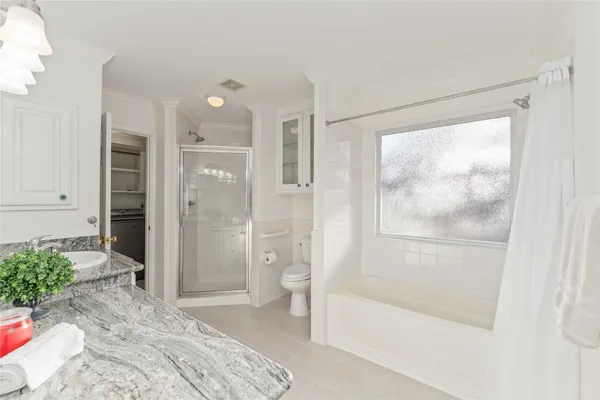 a bathroom with a glass shower door and a shower