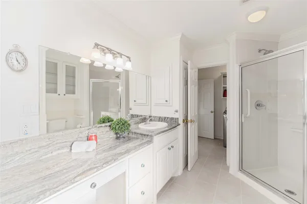 a spacious bathroom with a granite countertop sink mirror and shower