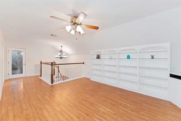 a view of a room with cabinet and a ceiling fan