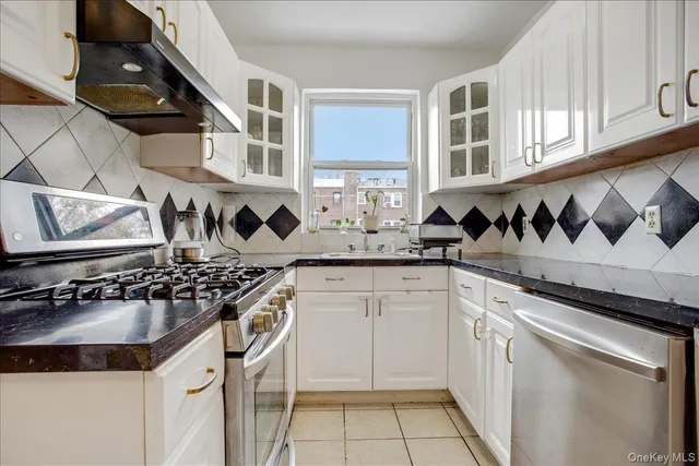 a kitchen with stainless steel appliances a sink stove and cabinets