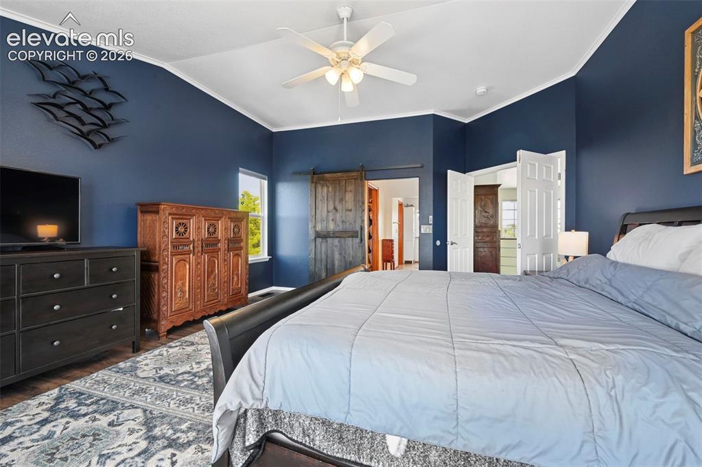 10643 Pictured Rocks Drive Peyton, CO 80831 - Photo 15 of 37 a bedroom with a bed and a television