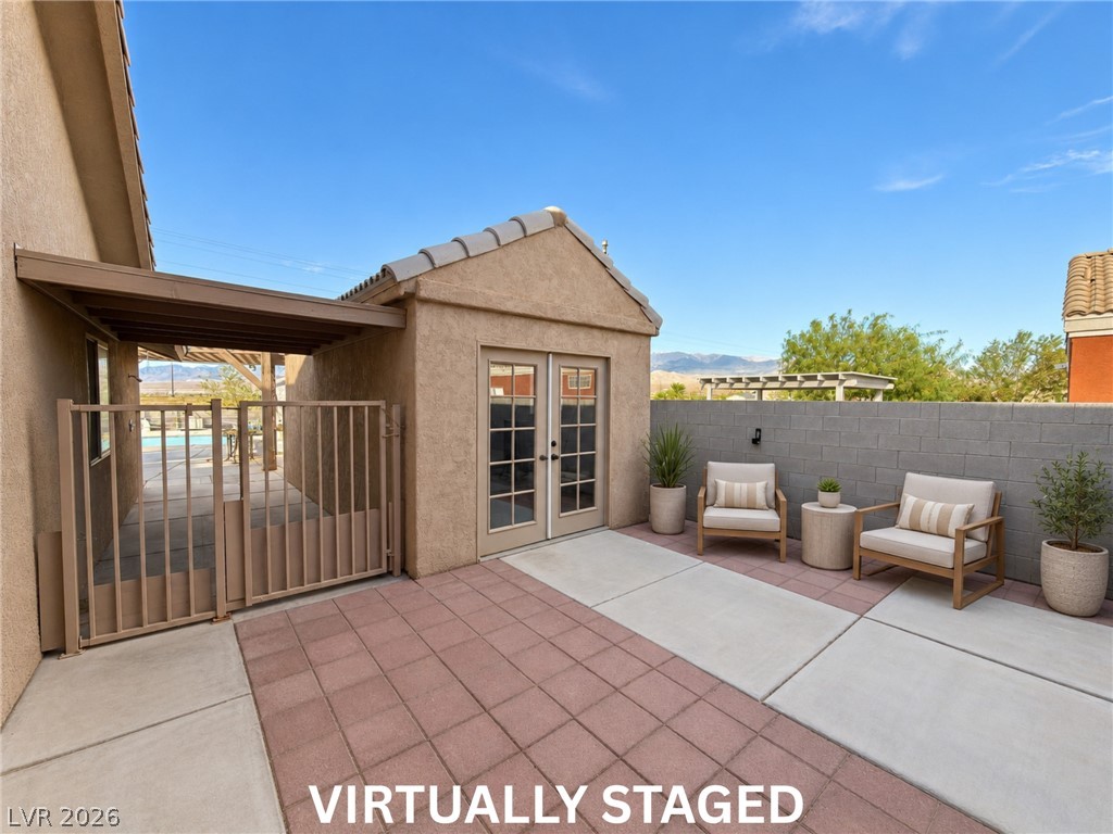 5470 Grain Mill Road Pahrump, NV 89061 - Photo 66 of 80 VIRTUALLY STAGED. Imagine the possibilities!
An inviting paved courtyard features a detached stucco outbuilding under clear blue desert skies.