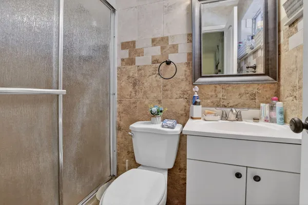 a bedroom with a bed a window and a chandelier