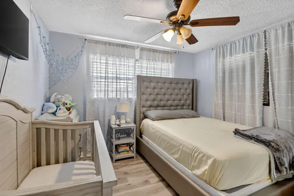 a bedroom with a bed and a large mirror