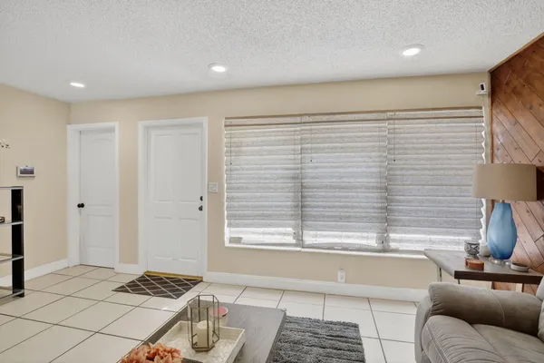 a living room with furniture a table and chairs
