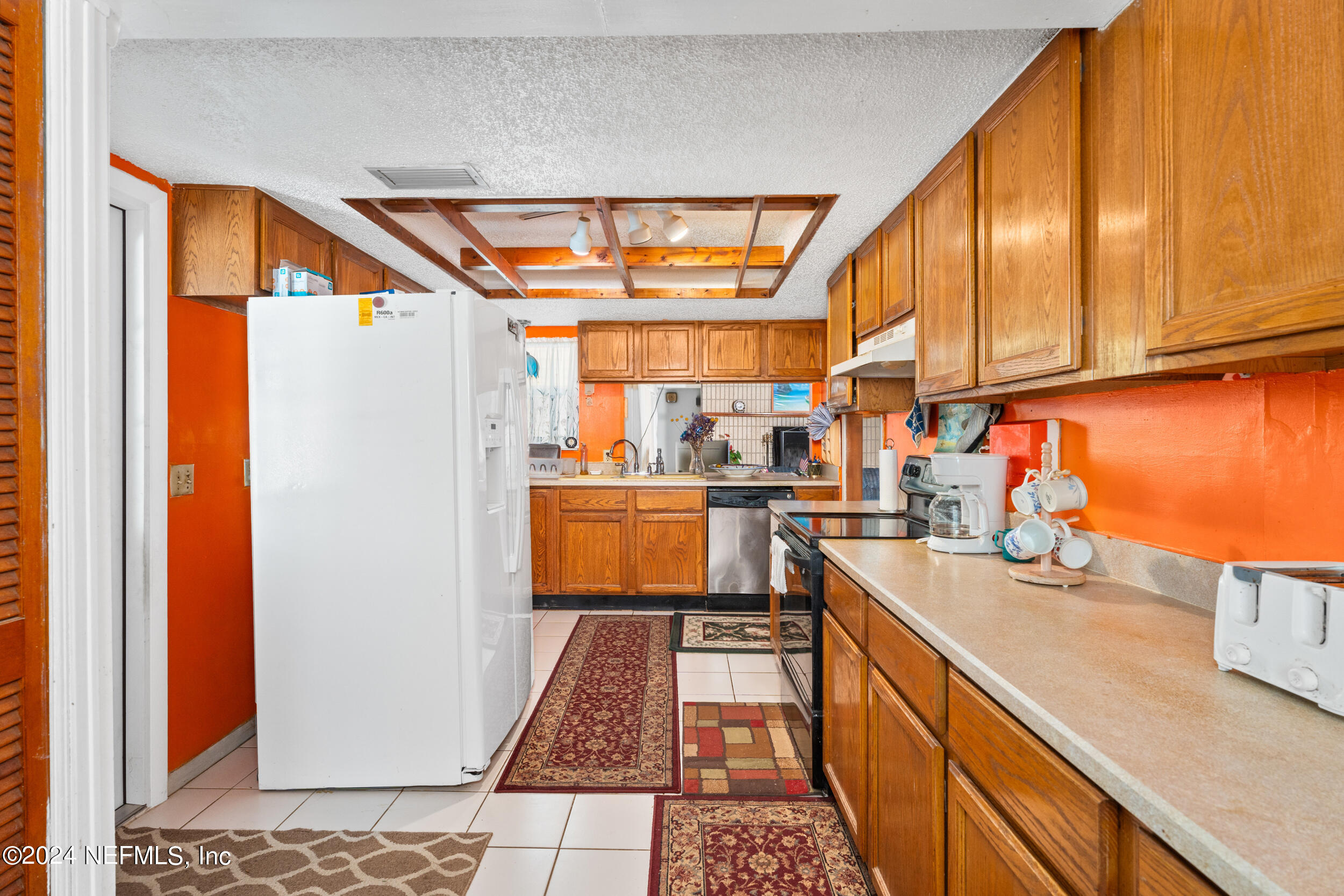 8080 Ibach Road Jacksonville, FL 32216 - Photo 11 of 34 a kitchen with stainless steel appliances granite countertop a refrigerator and a sink