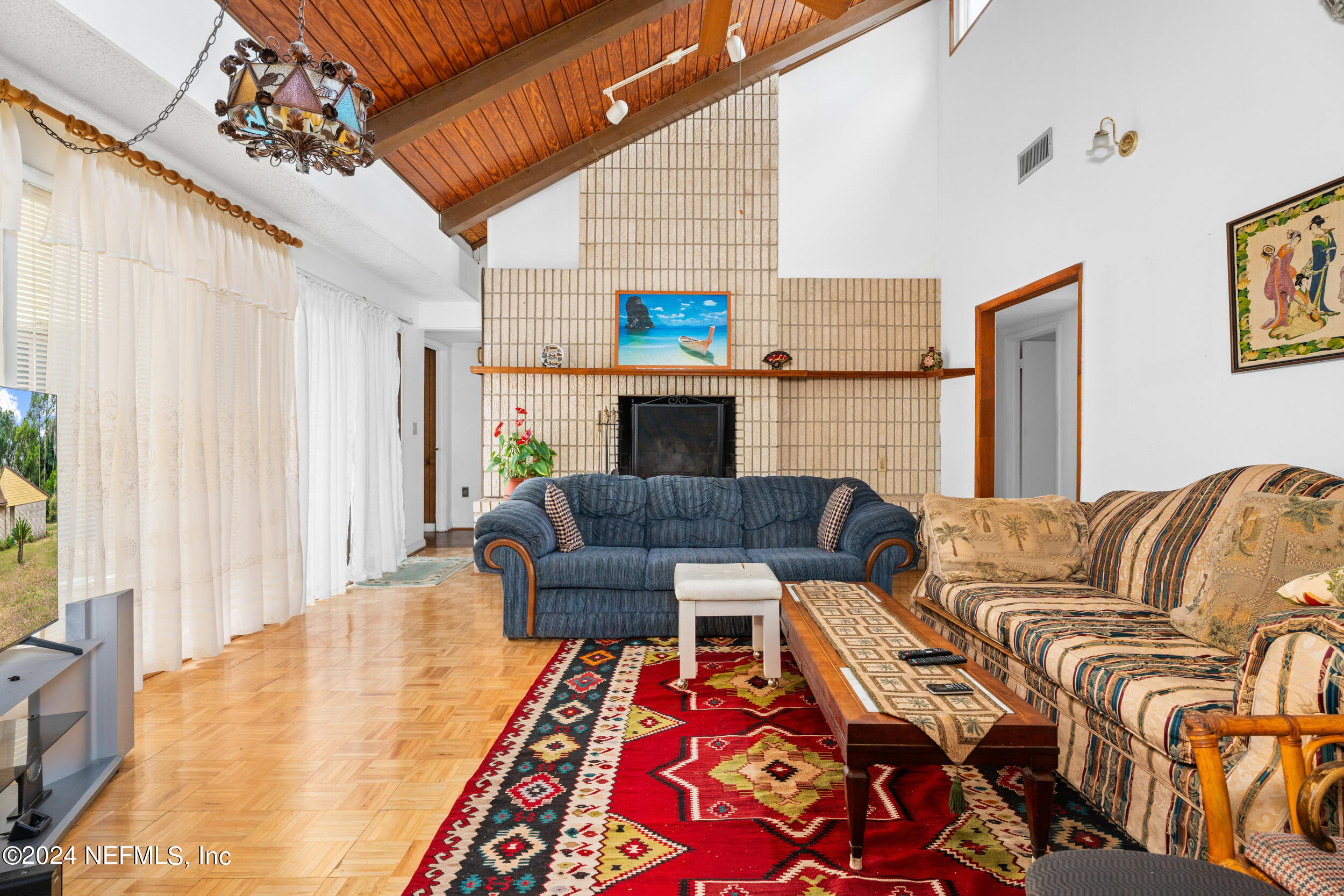 8080 Ibach Road Jacksonville, FL 32216 - Photo 21 of 34 a living room with fireplace furniture and a flat screen tv