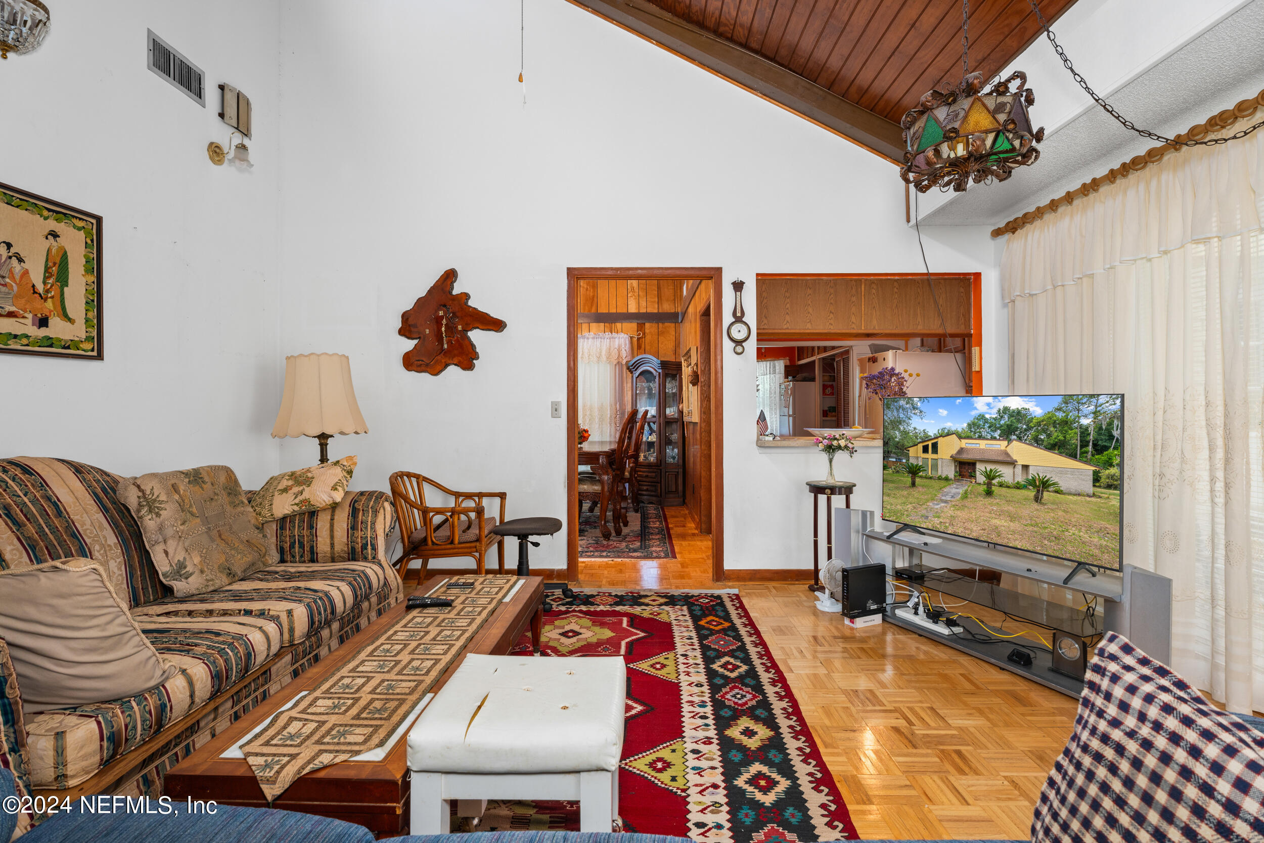 8080 Ibach Road Jacksonville, FL 32216 - Photo 22 of 34 a living room with furniture and a flat screen tv