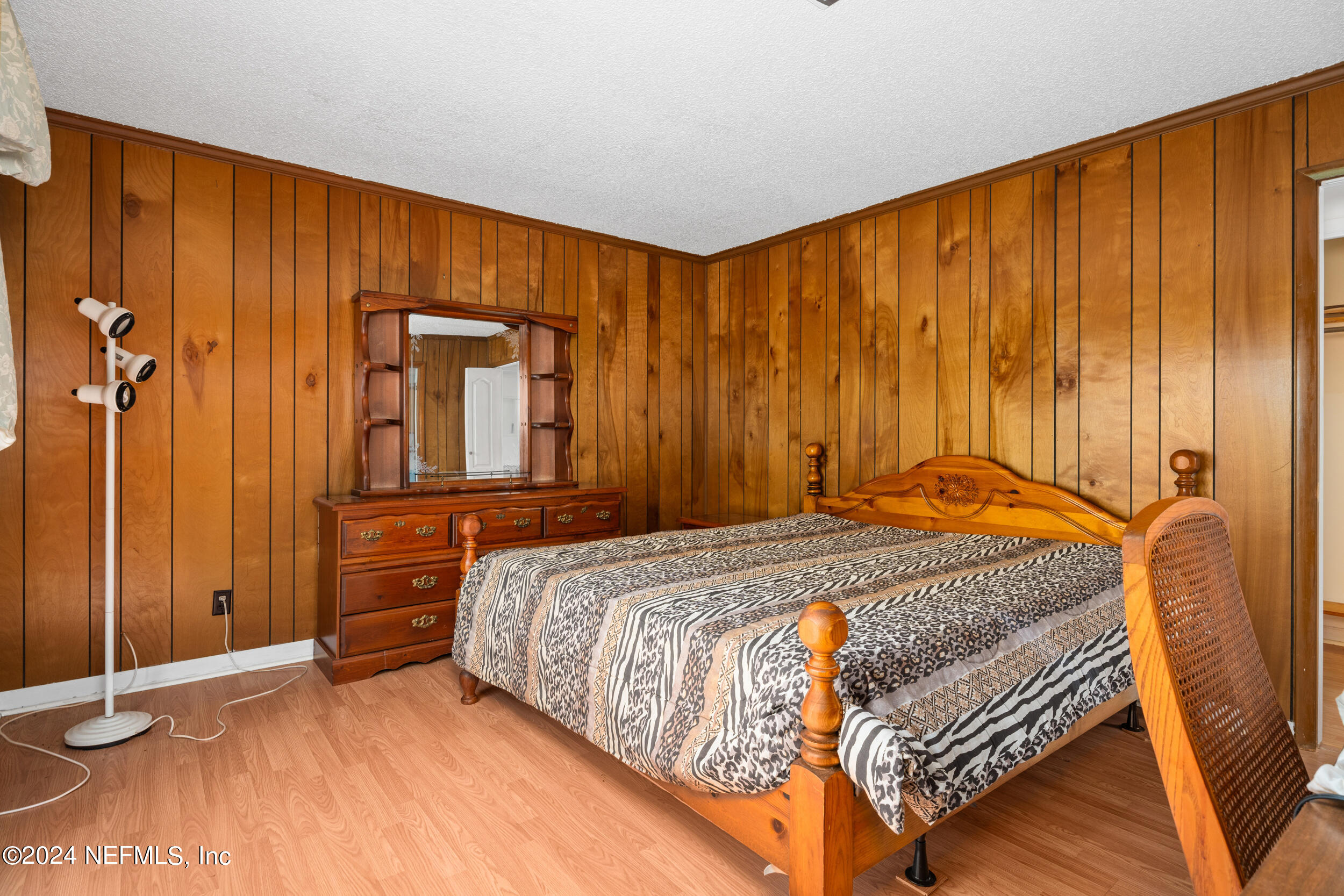 8080 Ibach Road Jacksonville, FL 32216 - Photo 23 of 34 a bed sitting in a spacious bedroom next to a window