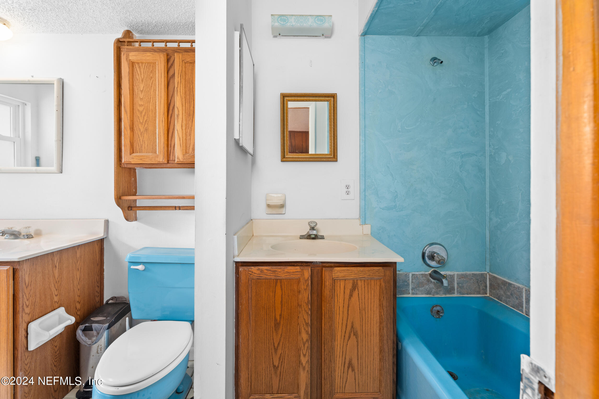 8080 Ibach Road Jacksonville, FL 32216 - Photo 26 of 34 a bathroom with a sink a toilet and mirror