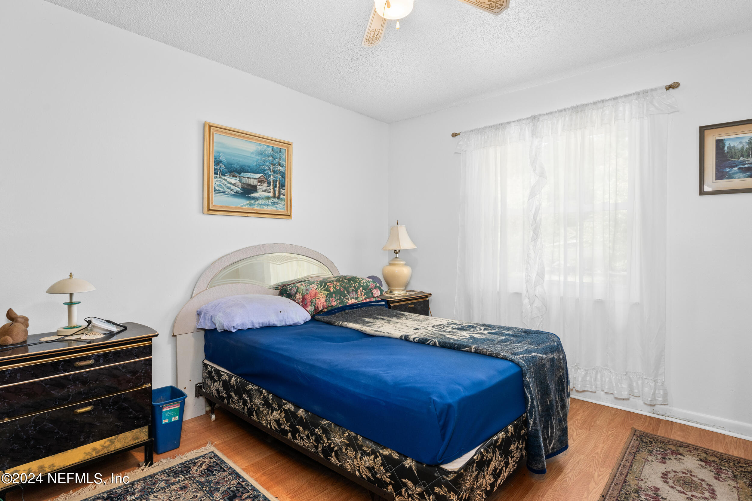 8080 Ibach Road Jacksonville, FL 32216 - Photo 32 of 34 a bed sitting in a bedroom next to a window