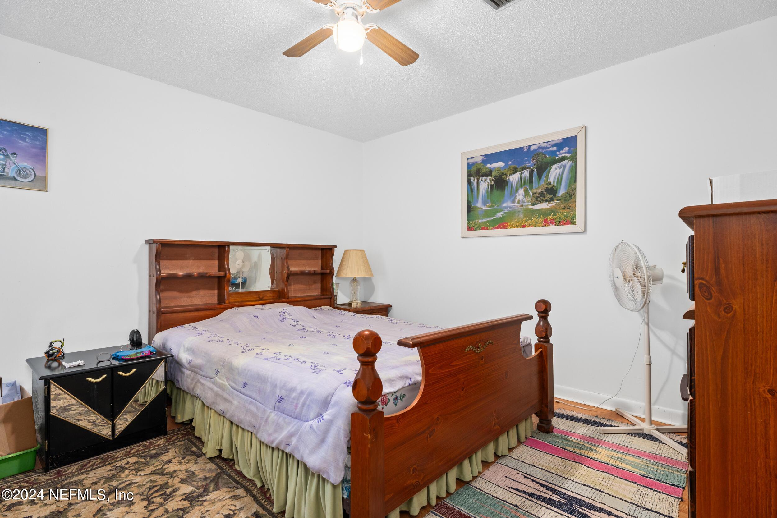 8080 Ibach Road Jacksonville, FL 32216 - Photo 33 of 34 a bedroom with a bed and wooden floor