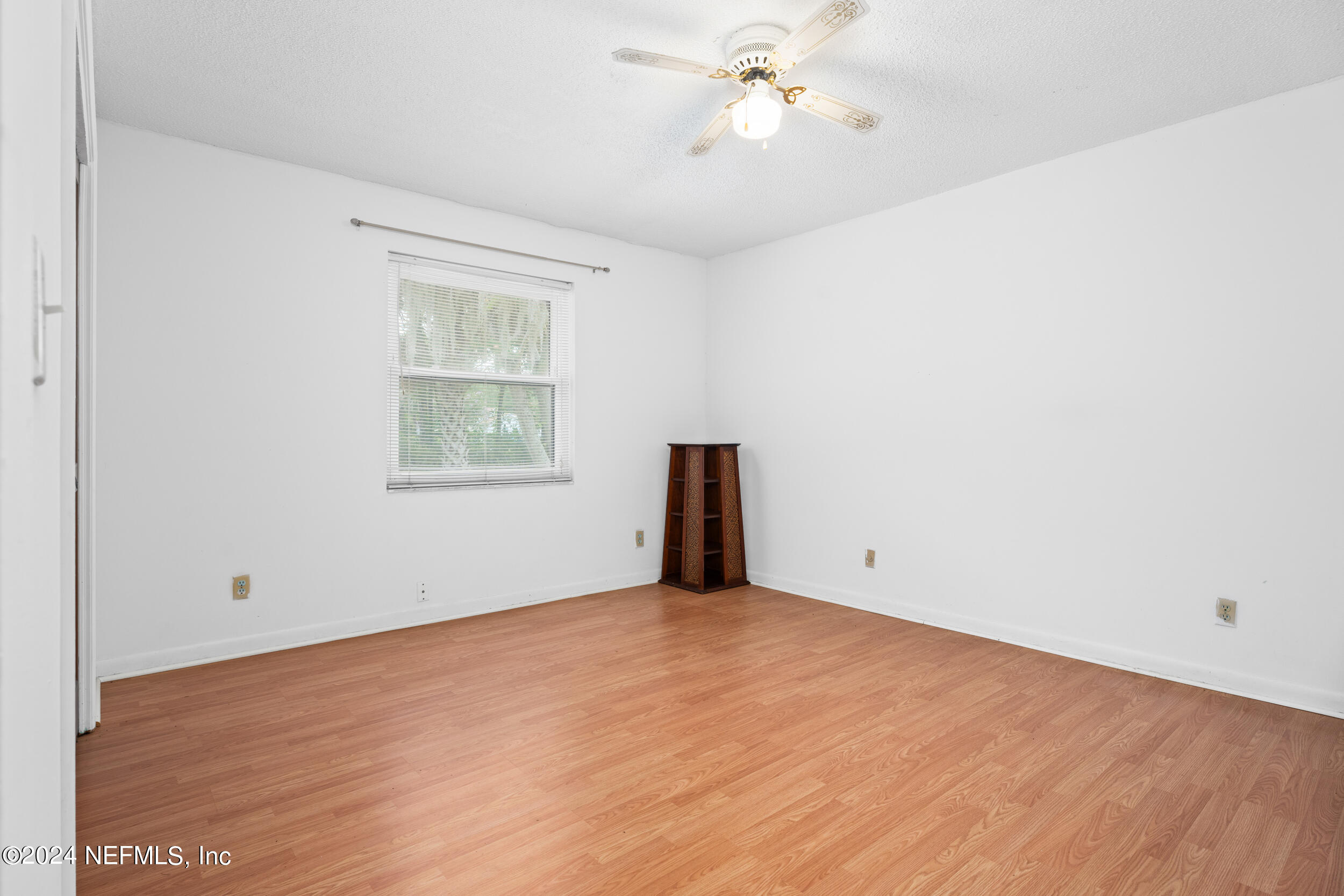 8080 Ibach Road Jacksonville, FL 32216 - Photo 34 of 34 an empty room with a window and a ceiling fan