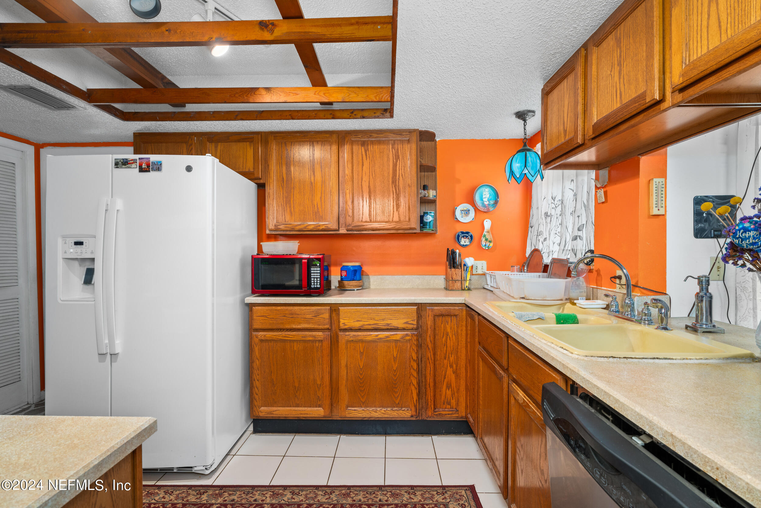 8080 Ibach Road Jacksonville, FL 32216 - Photo 10 of 34 a kitchen with stainless steel appliances a sink and a refrigerator