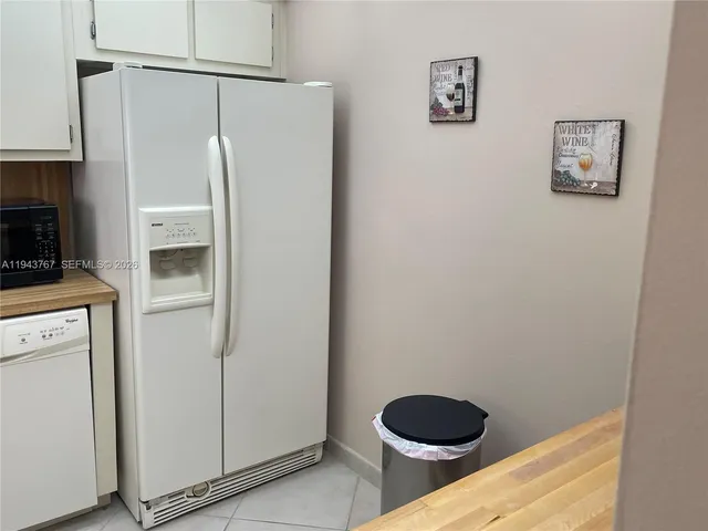 a bedroom with a bed and a mirror on dresser