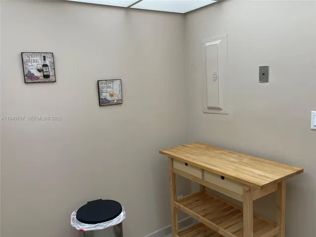 a bedroom with a bed and a flat tv screen on a dresser