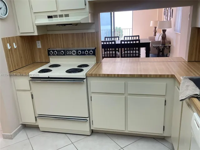 a bedroom with a bed and a flat tv screen on a dresser