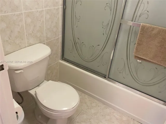 a living room with furniture a rug and a chandelier