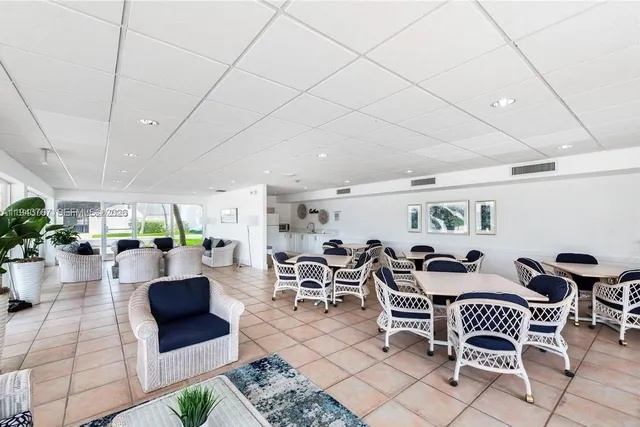 a lobby with furniture and potted plants