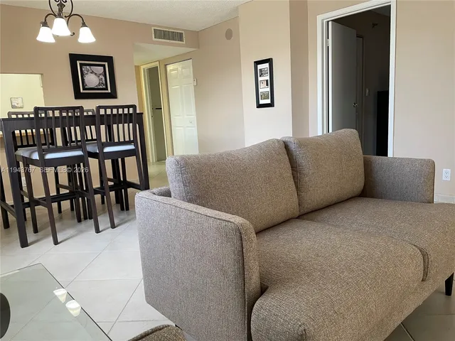 a view of a dining room with furniture and window